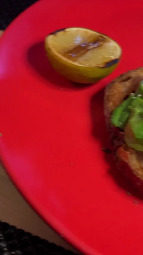 Avocado sandwich and serve on two plates red and blue dinner for two a slice of Stock Footage 292934771
