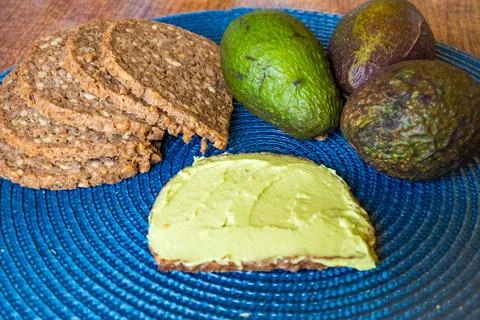 Avocado sandwich on dark rye bread made with fresh sliced avocados from above Stock Photos