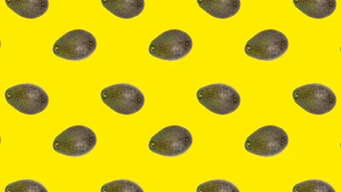 An Avocado in seamless loop pattern on a yellow background. Exotic fruits Stock Footage 222322821