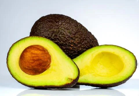 Avocado with seed isolated on white background. Source of omega 3 from natu.. 库存照片