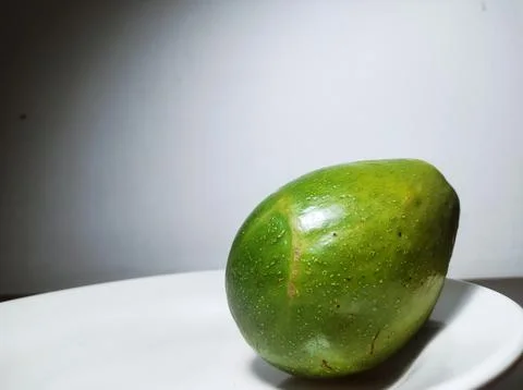 Avocado on Side of White Plate Stock Photos