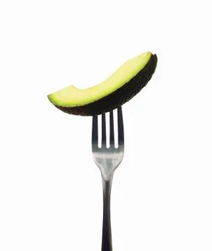 Avocado Slice on a Fork; White Background 库存照片