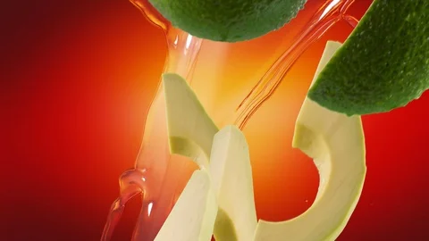 Avocado with Slices and Splash Falling on Red Background Vídeo Stock 122704168