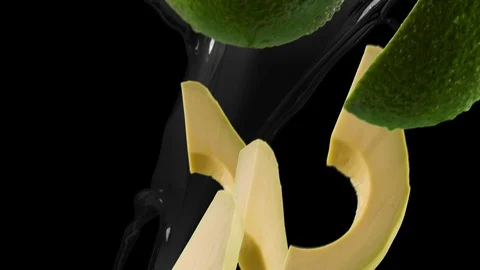 Avocado with Slices and Splash Falling on Black Background 库存影片 122704268