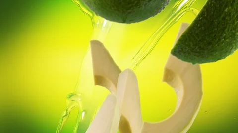 Avocado with Slices and Splash Falling on Lime Green Background Stock Footage 122704518