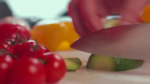 Avocado slices are cut with a large kitchen knife. Video stock 194150034