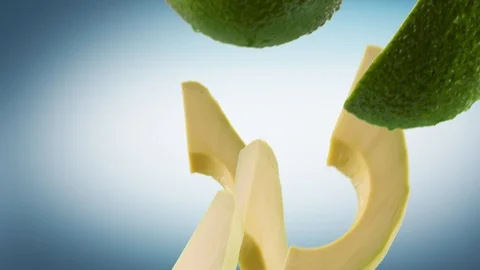 Avocado with Slices Falling on Cyan Background Stock Footage 122703678