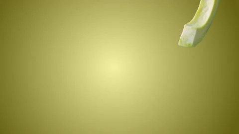 Avocado with Slices falling on yellow background Stock Footage 130671936