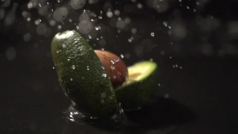 Avocado slow motion closeup falling in water macro Stock Footage 124735199
