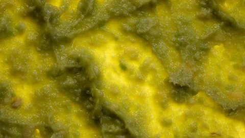 Avocado smash rotating in 4K. Closeup flat-lay view. 動画素材 89891462