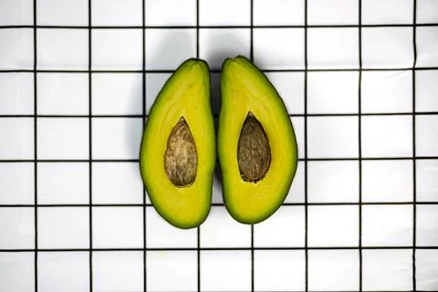 Avocado On A Square Table Stock Photos