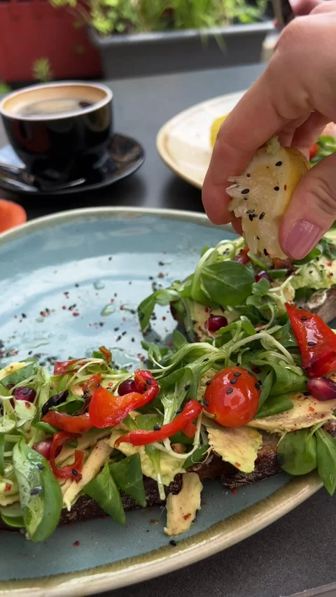 Avocado toast being sprinkled with lemon juice. Vertical video Stock Footage 246355952