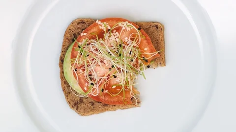 Avocado toast bite by bite looped stop motion. Healthy food concept Stock Footage 128926215