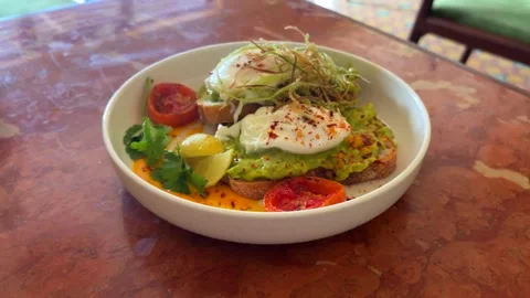 Avocado Toast with Eggs Plate Cafe Table Breakfast Meal Stock Footage 333827731