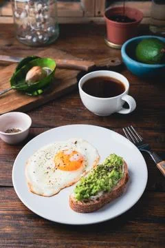 Avocado toast with fried egg Stock Photos