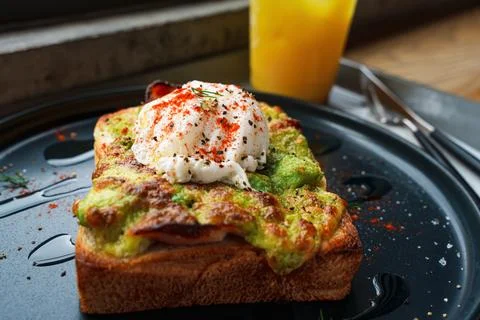 Avocado Toast with Poached Egg for Breakfast Stock Photos