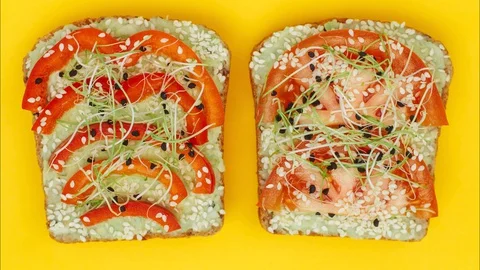 Avocado toasts changing its places and disappearing. Looped stop motion. Stock Footage 128926214