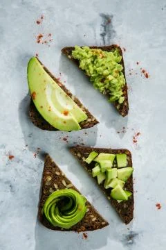 Avocado toasts on marble background Stock Photos