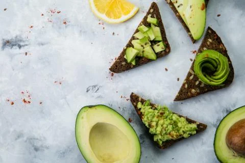 Avocado toasts on marble background Stock Photos