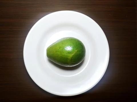 Avocado on a white plate Stock Photos