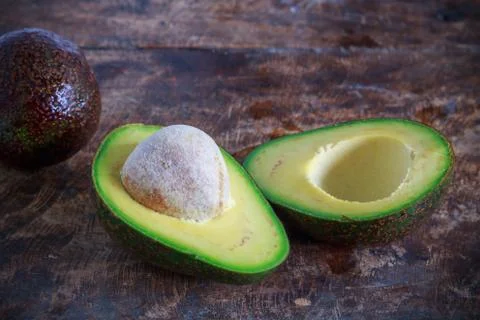 Avocado on wooden background Stock Photos