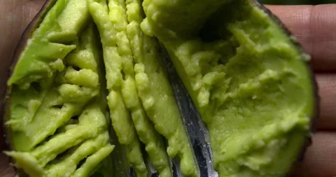 Avocados being squeezed with a fork, close-up Stock Footage 301017341