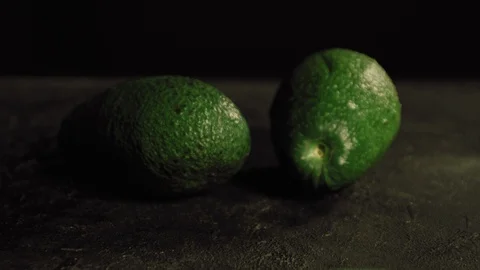 Avocado's on black table Stock Footage 113081400