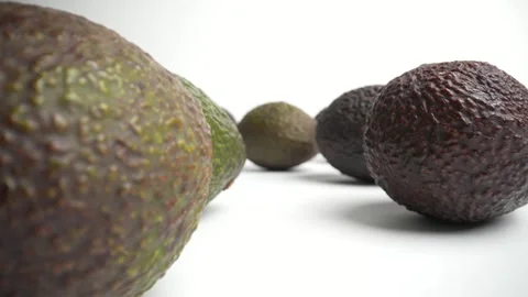 Avocados on a table in a macro probe lens dolly shot Stock Footage 249945786