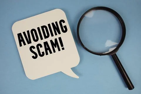 Avoiding Scam! text with magnifying glass on blue background Stock Photos