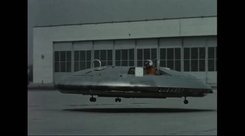 Avrocar hovering over concrete ground Stock Footage