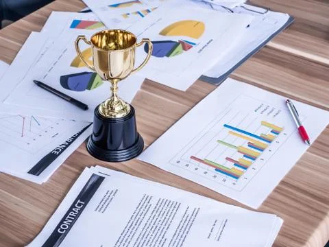 Award trophy on working table with document and contract Stock Photos