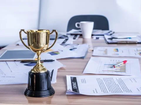 Award trophy on working table with document and contract Stock Photos