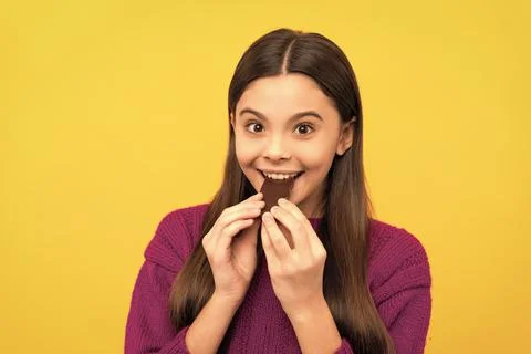 Award yourself with one bite. Happy girl eat chocolate. Chocolate eating Stock Photos