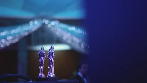 Awards statuette in the form of an Oscar standing on the presentation table. Stock Footage 145368573