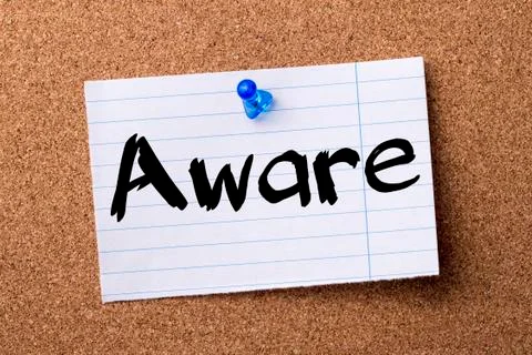 Aware - teared note paper pinned on bulletin board Stock Photos