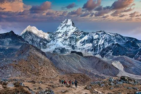 Awe inspiring peak of Ama Dablam - trekkers in the foreground, Himalayas, Nepal Stock Photos