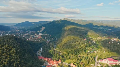 Awesome Aerial view of mountain range, road, river and fir forest with village Stock Footage 121311720