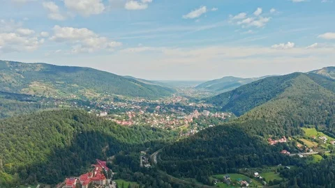 Awesome Aerial view of mountain range, road, river and fir forest with village Stock Footage 121926650