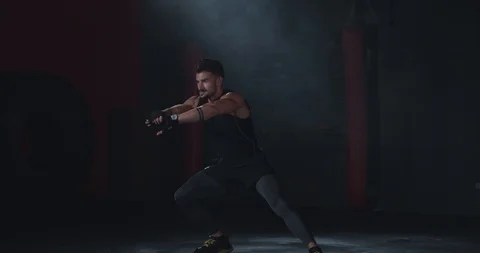 Awesome athletic guy stretching his legs before starting his intense workout in Stock-Footage 116901323