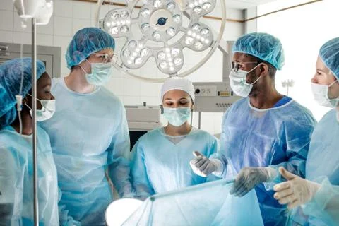 Awesome diverse doctors solving problems during operation 写真素材
