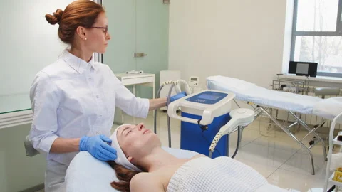 Awesome doctor doing RF lifting to a client in the clinic Stock Footage 101683755