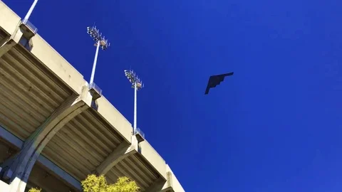 Awesome fly over of a B2 Stealth Bomber over a stadium. Stock Footage 100009548