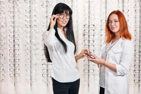 Awesome good looking model and doctor holding glasses and looking at the camera Stock Photos
