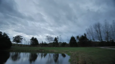Awesome Motion Time Lapse of Clouds Rolling over a Farm and Pond in Kentucky Stock Footage 120340817