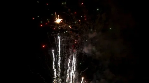 Awesome multi-colored launch of multi-colored fireworks in the night sky Stock Footage 115495098