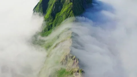 Awesome overhead panorama. Dense white clouds crawl over green mountains range Stock Footage 169092200