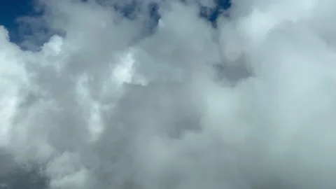Awesome pilot point of view while flying through white cumulus clouds in a Video stock 200818327