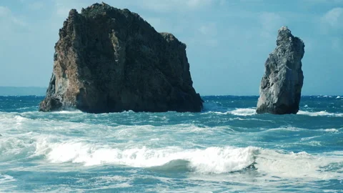 Awesome power of waves breaking over a rock in west coast of Sardinia Stock Footage 140492420