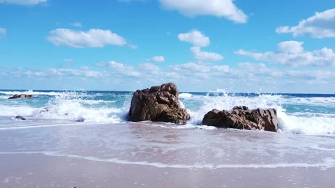 Awesome power of waves breaking over a rock in south coast of Sardinia island Stock Footage 148540416
