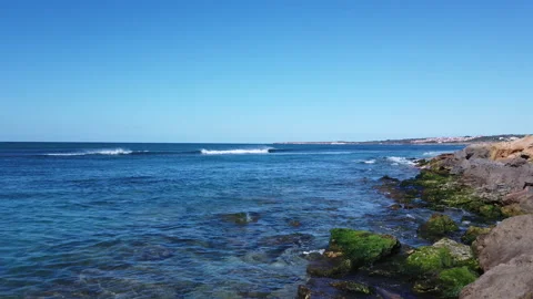 Awesome power of waves breaking over a rock in south coast of Sardinia island Stock Footage 148541104